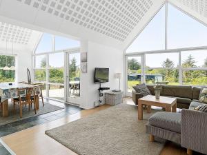 a living room with a couch and a table at 5 star holiday home in Blokhus in Blokhus +44 photos