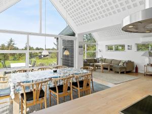 a living room with a large table and chairs at 5 star holiday home in Blokhus in Blokhus