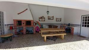a room with a wooden table and a play house at Casa Machuca - espaço exclusivo com piscina in Tomar