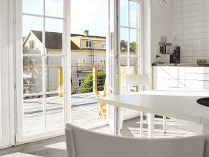 a kitchen with a white table and a large window at 4 person holiday home in Skärhamn-By Traum in Skärhamn