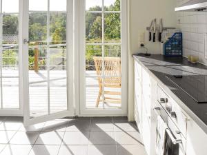 a kitchen with a sliding glass door with a patio at 4 person holiday home in Skärhamn-By Traum in Skärhamn