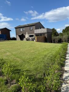 a house with a green lawn in front of it at Downtown apartment in Stavanger
