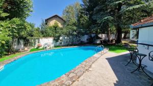 a swimming pool in the backyard of a home at Vila Blue Mountain Lake in Ledinci