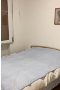 a white bed in a room with a window at Casa Sasha in Lido Adriano