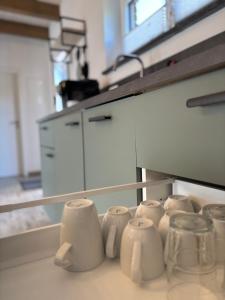 a row of coffee cups sitting on a counter at Fichtelcube de in Schönwald