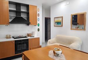 a kitchen with a table and a chair in a room at Casa Vacanze Philia 