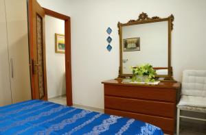 a bedroom with a dresser and a mirror and a bed at Casa Vacanze Philia 