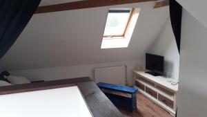 a living room with a tv and a window at De Oude Smederij in Spier