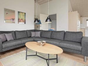 a living room with a couch and a table at 8 person holiday home in Løkken-By Traum in Løkken