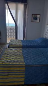 a bedroom with a bed and a window with a view at Appartement vue sur mer à Mahdia in Mahdia +12 photos