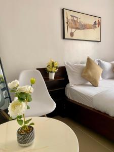 a hotel room with a bed and a table with a chair at Studio Apartment in Nairobi West in Nairobi +26 photos