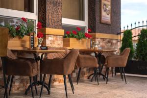 a row of tables and chairs in a restaurant at ANTONIO Apartments in Spišské Tomášovce