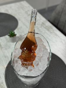 a bottle of beer in a glass bowl of ice at Casa Logascu in Bîlta