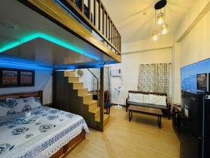 a bedroom with a bed and a staircase with blue lights at Happy Stays C - 300mbps - 65"TV NetFlix, Disney - Loft in Trece Martires