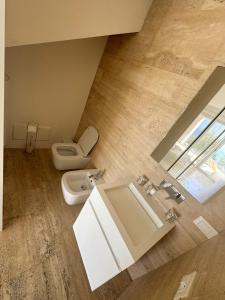 a bathroom with a white toilet and a sink at Mont des Olives - Cap D'ail- app4 in Saint-Antoine