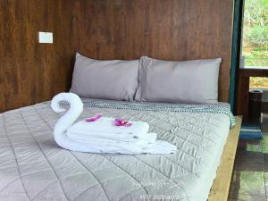 a swan towel and robe on a bed at Highland Homestay Kundasang in Ranau +23 photos