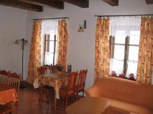 a living room with a table and chairs and windows at Holiday Home in Zátor near Ještěd Ski Resort in Zátor