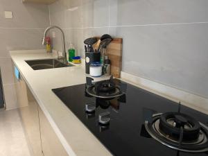 a kitchen with a black stove top in a kitchen at The Garden Nook in Dar es Salaam