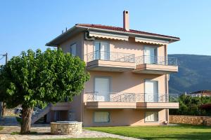 a large building with a tree in front of it at Villa Eudora Nafpaktos in Nafpaktos
