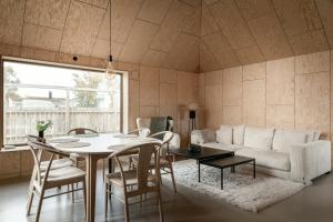 a living room with a table and a couch at Kivikshusen in Kivik