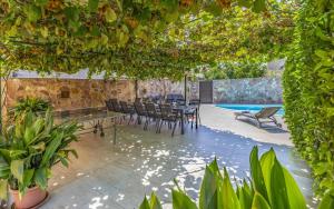 a patio with a table and chairs and a pool at Ferienhaus mit Privatpool für 13 Personen ca 192 qm in Peroj, Istrien Istrische Riviera in Peroj