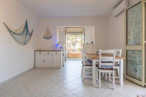a kitchen with a table and chairs in a room at Mare fuori in Villasimius