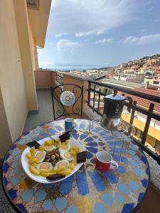 a plate of food on a table on a balcony at Mare fuori in Villasimius
