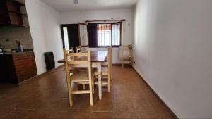 a kitchen with a table and chairs in a room at La casa de la abu in Carmen de Areco +9 photos