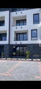 a large white building with windows and a courtyard at Aprtman SALE in Vrnjačka Banja