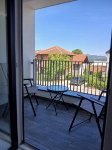 a view of a balcony with a table and chairs at Aprtman SALE in Vrnjačka Banja +2 photos