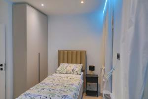 a small bedroom with a bed and a night stand at Casa Dellˇ Amore in Bihać +92 photos