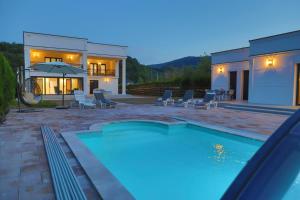 a house with a swimming pool in front of a house at Casa Dellˇ Amore in Bihać