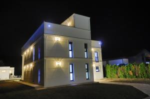 a white house at night with its lights on at Casa Dellˇ Amore in Bihać