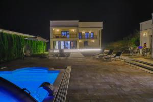 a house with a swimming pool at night at Casa Dellˇ Amore in Bihać