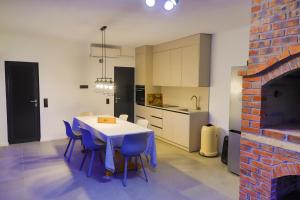 a kitchen with a table and chairs and a fireplace at Casa Dellˇ Amore in Bihać