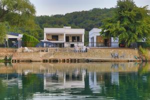 a house on the shore of a body of water at Casa Dellˇ Amore in Bihać +88 photos