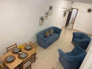 a living room with a couch and a table and chairs at DK Lodge in Kandy