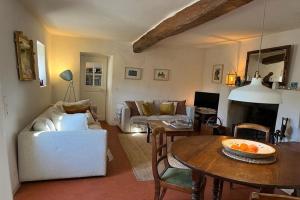 a living room with a couch and a table at Farmhouse, with large pvt pool in Provence in Draguignan