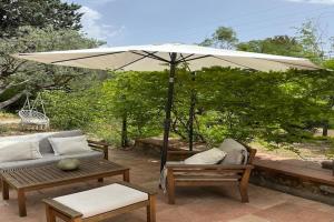 a patio with a couch and an umbrella at Farmhouse, with large pvt pool in Provence in Draguignan +32 photos