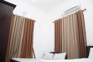 Ένα ή περισσότερα κρεβάτια σε δωμάτιο στο Meera Bayside Villas