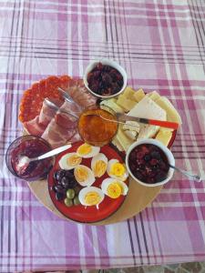 a tray of food with eggs and other foods on a table at Kaj Nana & Dedo in Skopje