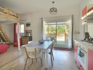 a kitchen and dining room with a table and chairs at Mon paradis in Maubec