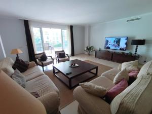 a living room with two couches and a coffee table at Charming 3 Bedroom Apartment in Puerto Sotogrande in Torreguadiaro