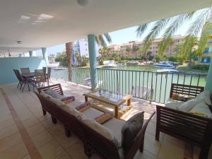a balcony with couches and a view of the water at Charming 3 Bedroom Apartment in Puerto Sotogrande in Torreguadiaro