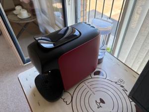 a toaster sitting on a table next to a window at City Getaway - Homestay in Edinburgh