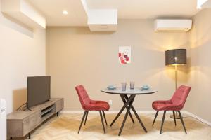 東京にあるThe underz suite residence Ikebukuroのテーブルと椅子とテレビのあるダイニングルーム