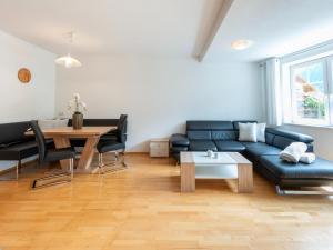 a living room with a blue couch and a table at Apartment in Strengen near Ski Bus in Strengen