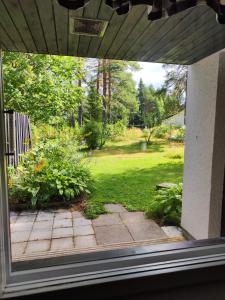 a view of a yard from a window of a house at Honkatilat majoitus as 2 in Kajaani +7 photos