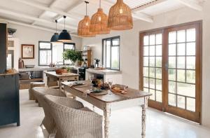 a kitchen with a large wooden table and chairs at Sh'mah Guest Cottage in Paddock