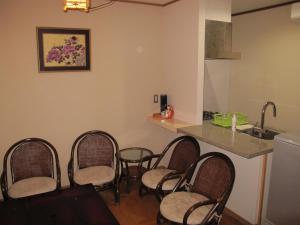 a group of chairs in a kitchen with a counter at Ikkyuan / Vacation STAY 3961 in Atami +18 photos
